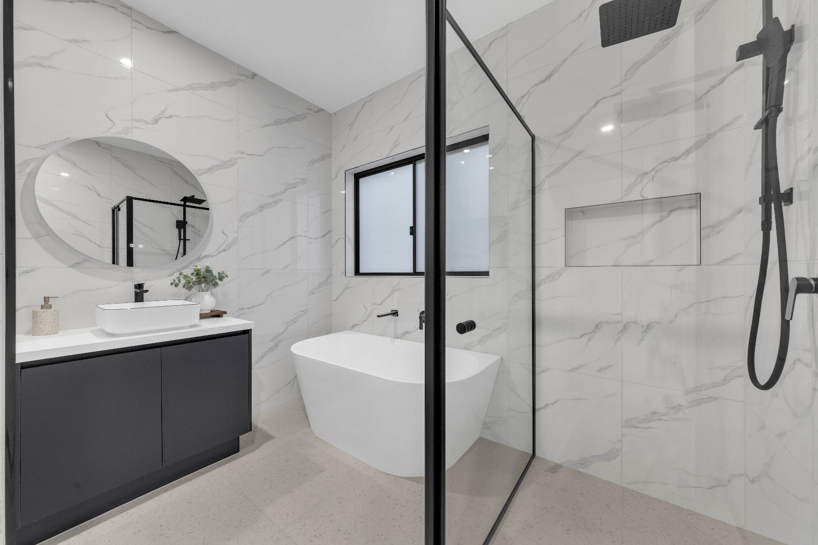 Ensuite with freestanding bath and marble tiling