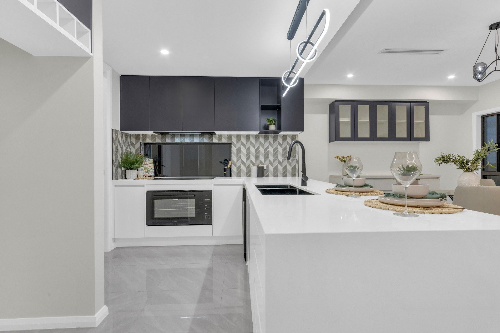Kitchen with stone island and dark cabinetry